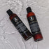 Beard wash and conditioner set in amber bottles, surrounded by water, ideal for a clean and soft beard.