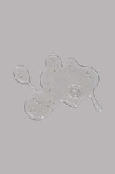 Transparent beard wash gel with bubbles on a grey background.