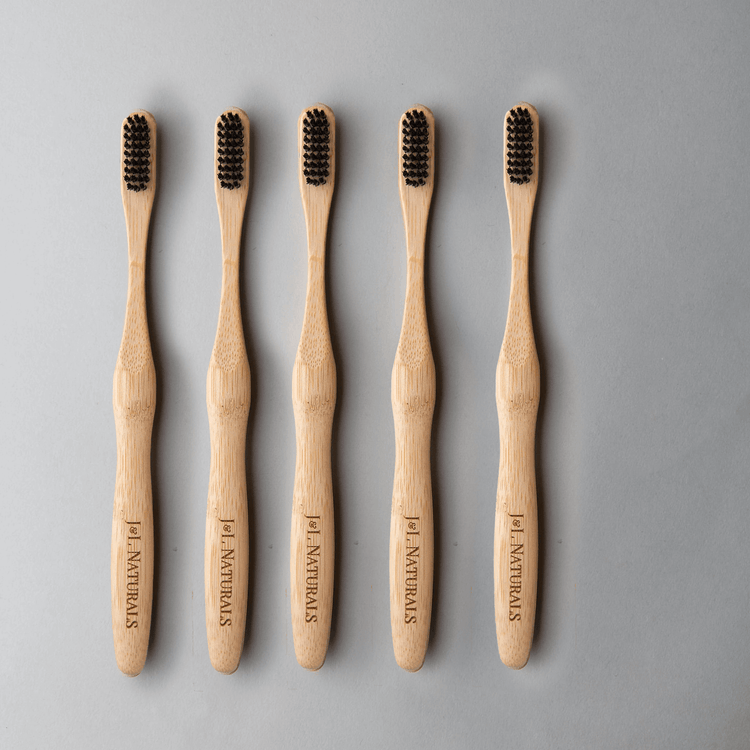 Bamboo toothbrush bundle (5-pack) with ergonomic handles and medium wavy bristles for eco-friendly oral care.