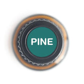 Top view of a Pine essential oil bottle with green label featuring the word &
