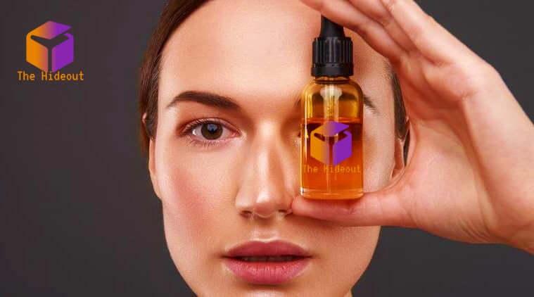 Woman holding facial oil from The Hideout, emphasizing skincare and beauty routine with natural products.