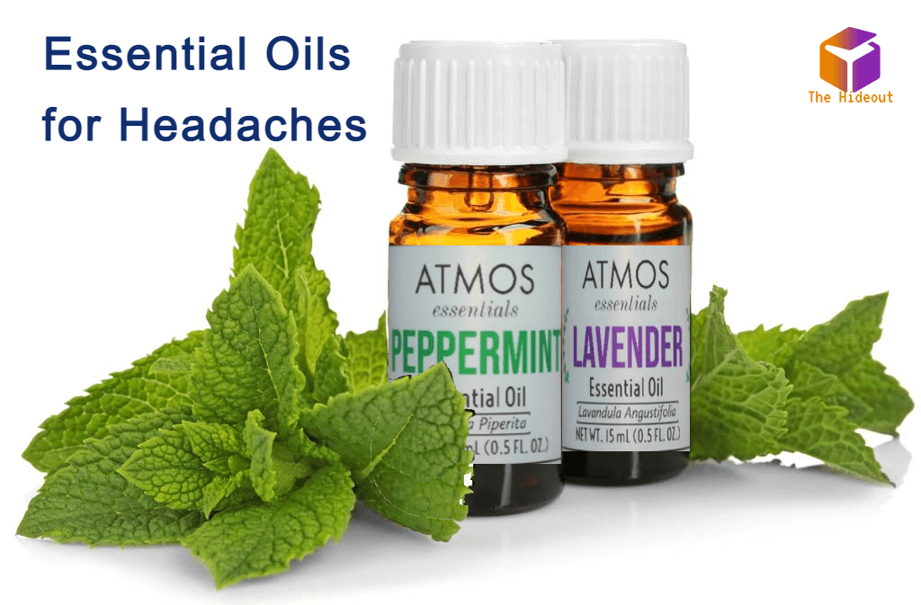 Bottles of peppermint and lavender essential oils for headache relief with fresh mint leaves.