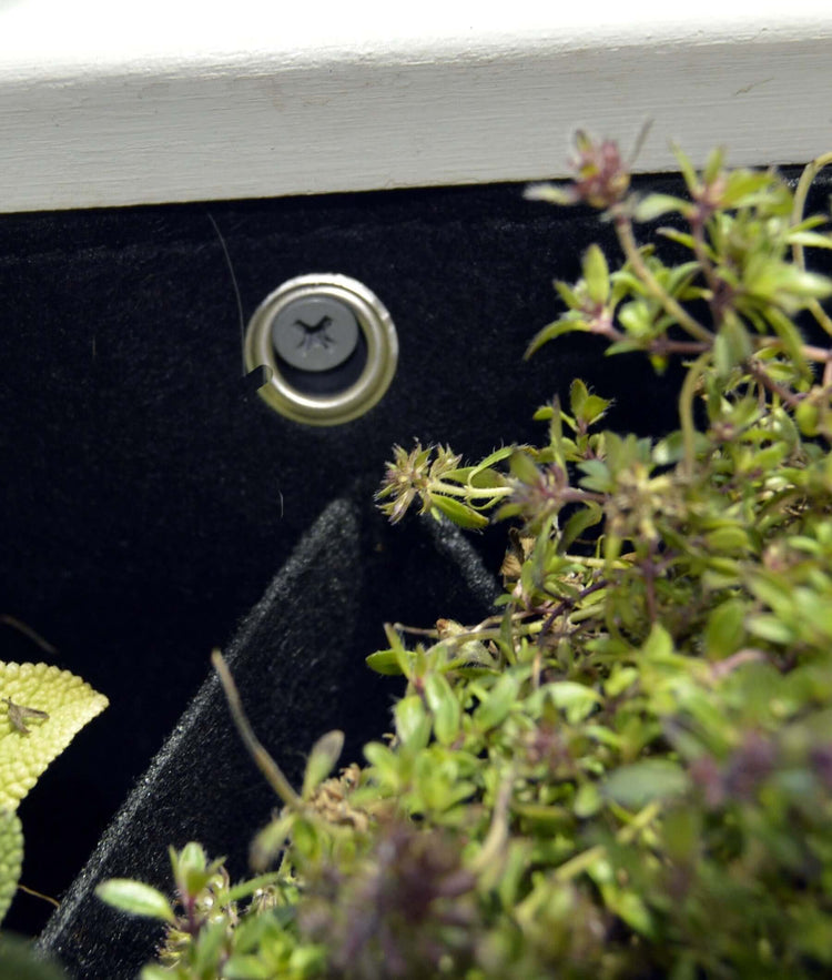 Close-up of the waterproof lining and drainage grommet in a 5 pocket indoor/outdoor eco-friendly planter.