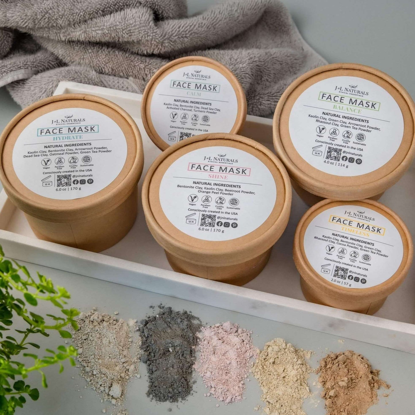 Assorted face masks in eco-friendly containers, featuring natural ingredients for targeted skin care.