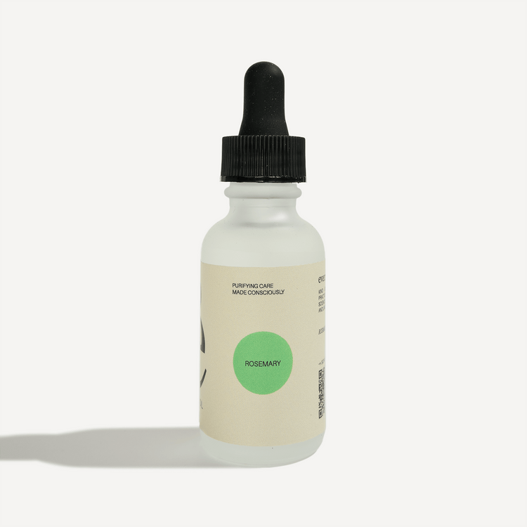 Rosemary essential oil dropper bottle with clean labeling, featuring a green cap and a minimalist design.