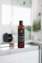 Beard wash bottle displayed in a modern bathroom setting, designed for cleaning and conditioning beards.