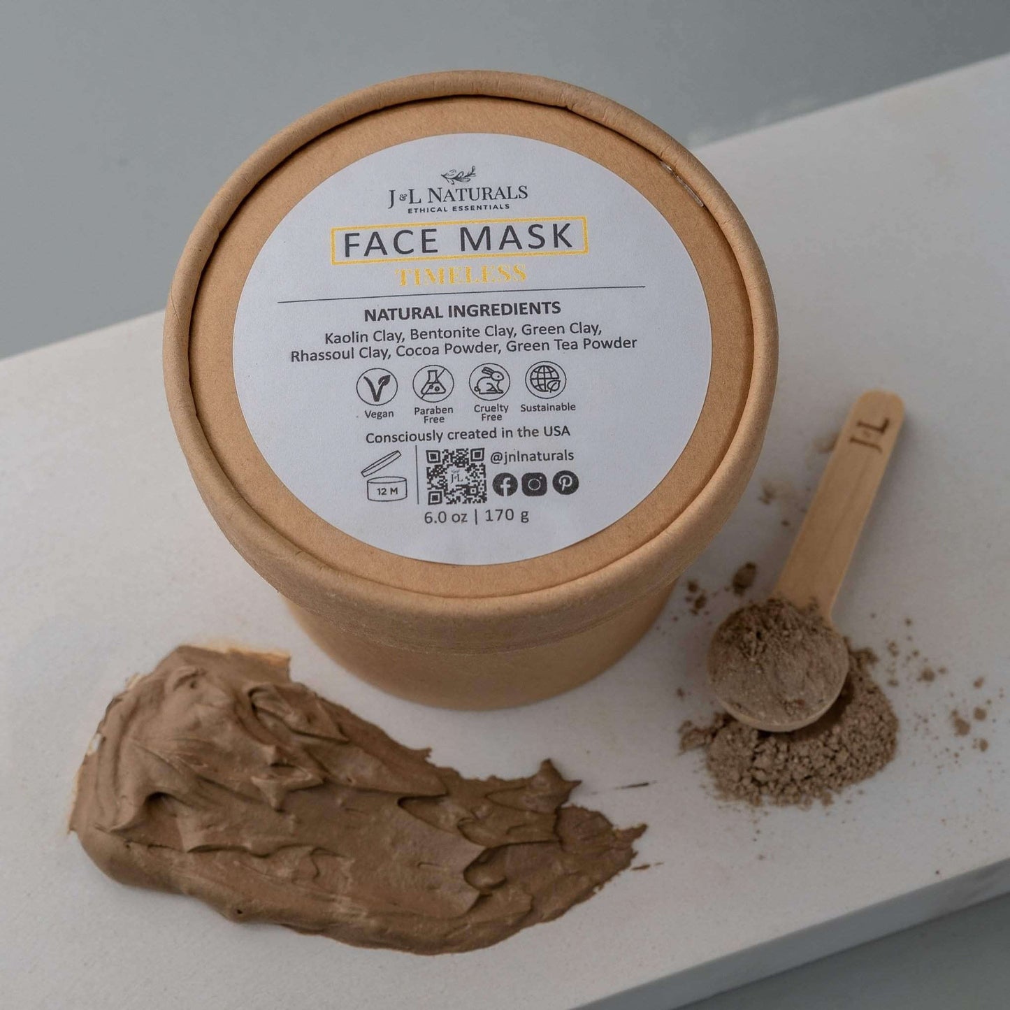 Natural face mask jar with ingredients like clay and green tea for smooth, clear skin treatment.