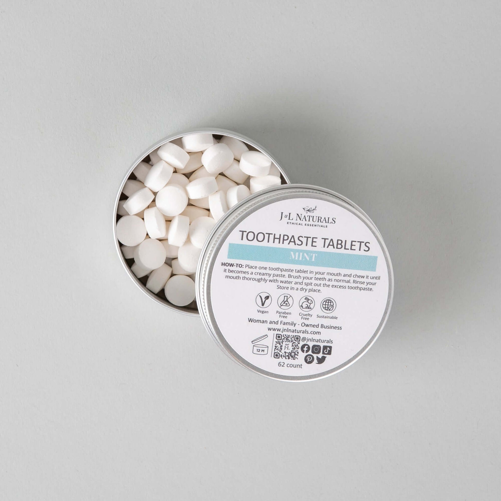 Eco-friendly toothpaste tablets in a tin, perfect for a fresh dental hygiene routine.