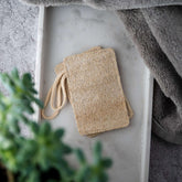 Natural loofah pads on a tray, ideal for exfoliating and promoting healthy, radiant skin. 100% biodegradable.