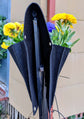 Cloth 6 pocket saddlebag planter with flowers, hanging on a fence for vertical gardening.