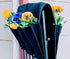 Cloth 6 pocket saddlebag hanging vertical garden planter with colorful flowers on a fence