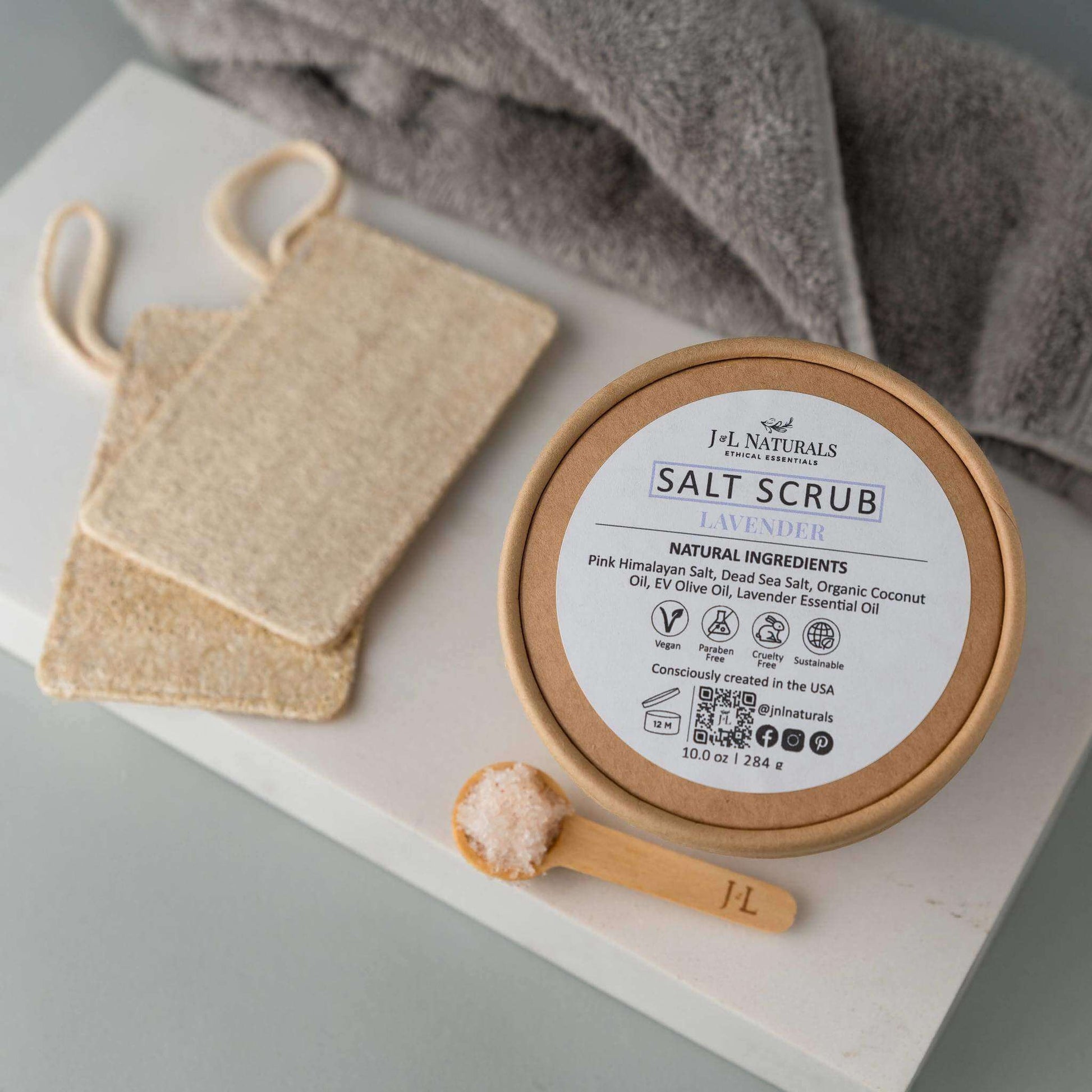 Natural lavender salt scrub with exfoliating ingredients and scoop, perfect for soft, moisturized skin.