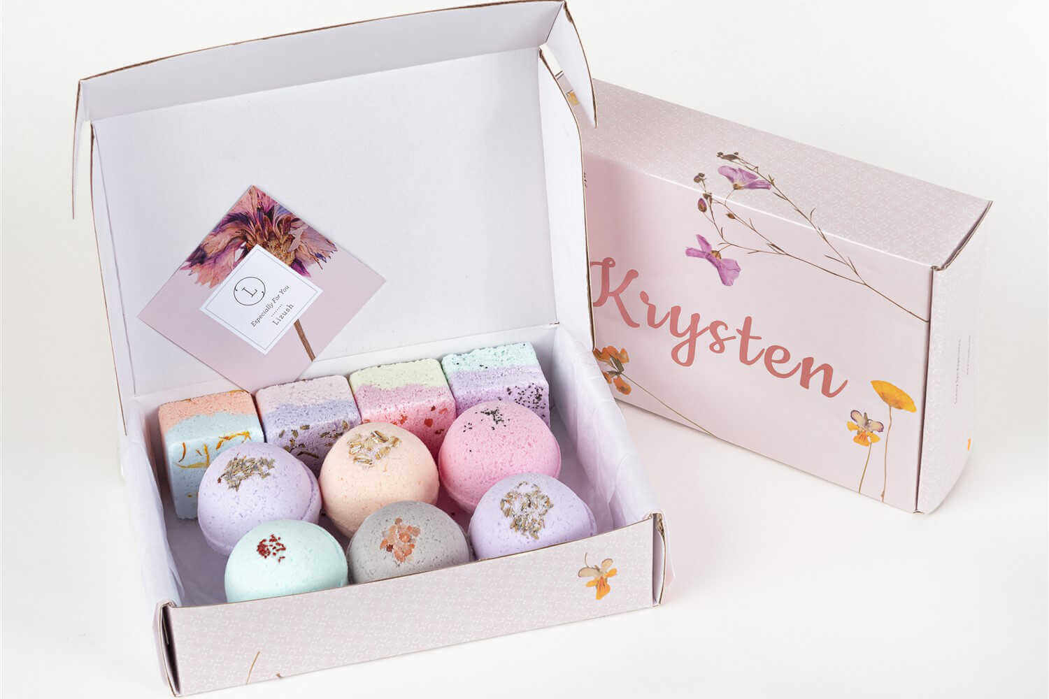 Natural bath bombs and shower steamers gift set in a beautiful box with pastel colors and a personalized label.