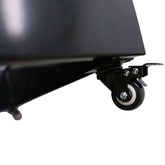 Close-up of a detachable wheel on a black metal planter, highlighting its mobility and design features.