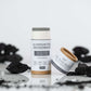 Extra-strength aluminum-free deodorant with activated charcoal, surrounded by activated charcoal pieces.