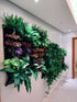 Indoor vertical living wall planter displaying lush greenery and colorful plants, enhancing room aesthetics and air quality.