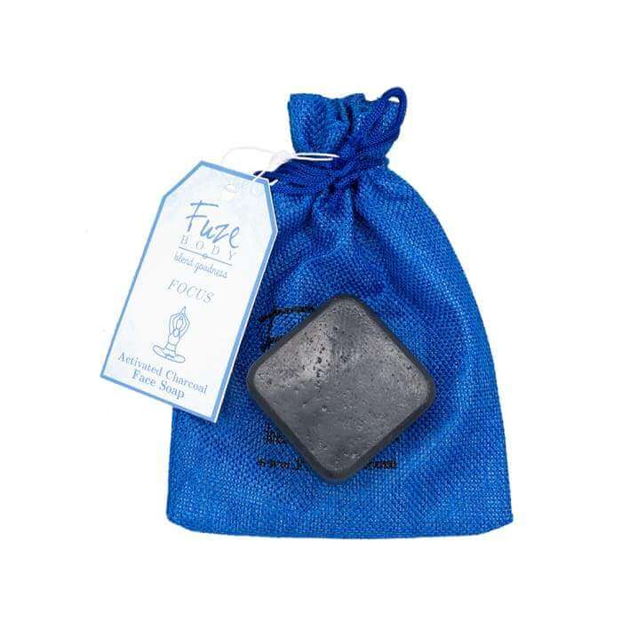 Focus Activated Charcoal Facial Soap in a blue pouch, featuring essential oils for skin nourishment and detoxification.