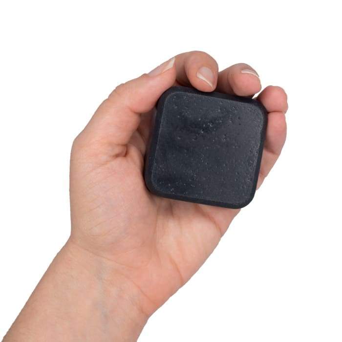 Focus Activated Charcoal Facial Soap held in hand, designed to detoxify and nourish the skin with natural ingredients.