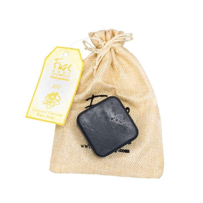 Joy Activated Charcoal Facial Soap in eco-friendly sachet bag for skin nourishment and detoxification.