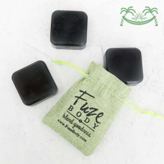 Just Chill Activated Charcoal Facial Soap bars in eco-friendly packaging by Fuze Body, promoting skin purity and nourishment.