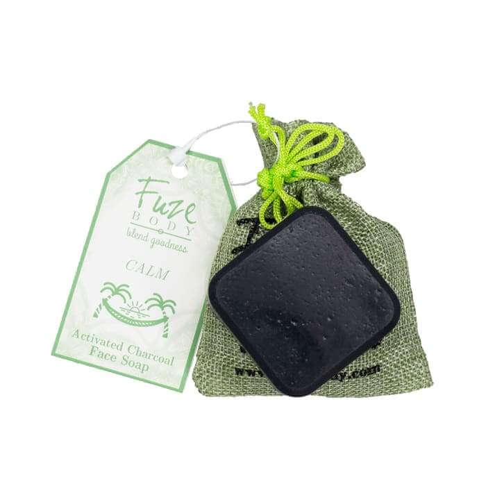 Activated charcoal facial soap in a green pouch, promoting skin detox and nourishment with essential oils.