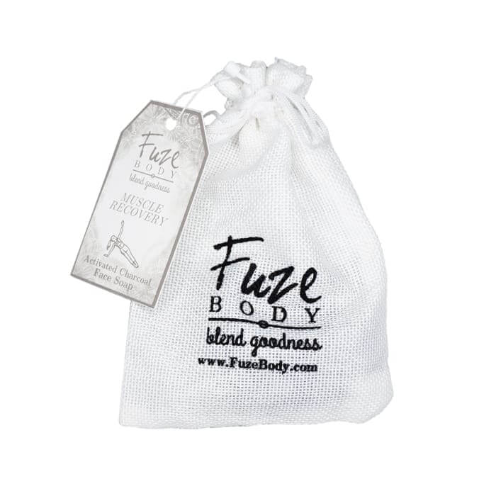 Muscle Recovery Activated Charcoal Facial Soap in a white sachet with a tag from Fuze Body.