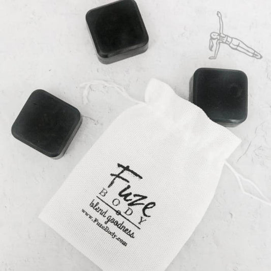 Muscle Recovery Activated Charcoal Facial Soap with Fuze Body pouch and charcoal bars, promoting skin purification and nourishment.