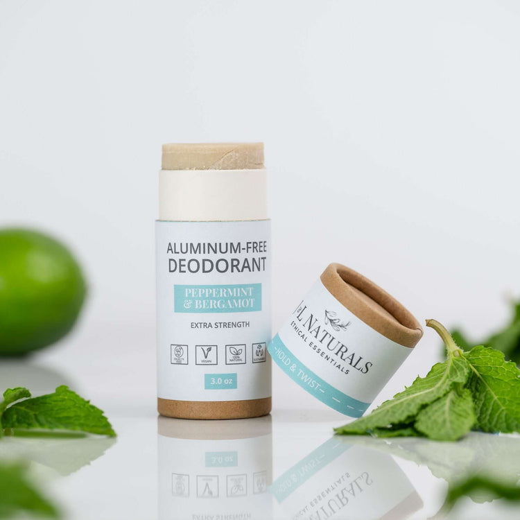 Extra-strength aluminum-free deodorant stick in Peppermint & Bergamot scent with natural ingredients, surrounded by fresh mint.