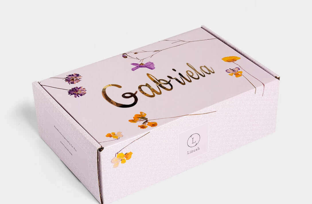 Handmade care package box with floral design, featuring the name 'Gabriela' in elegant gold lettering.