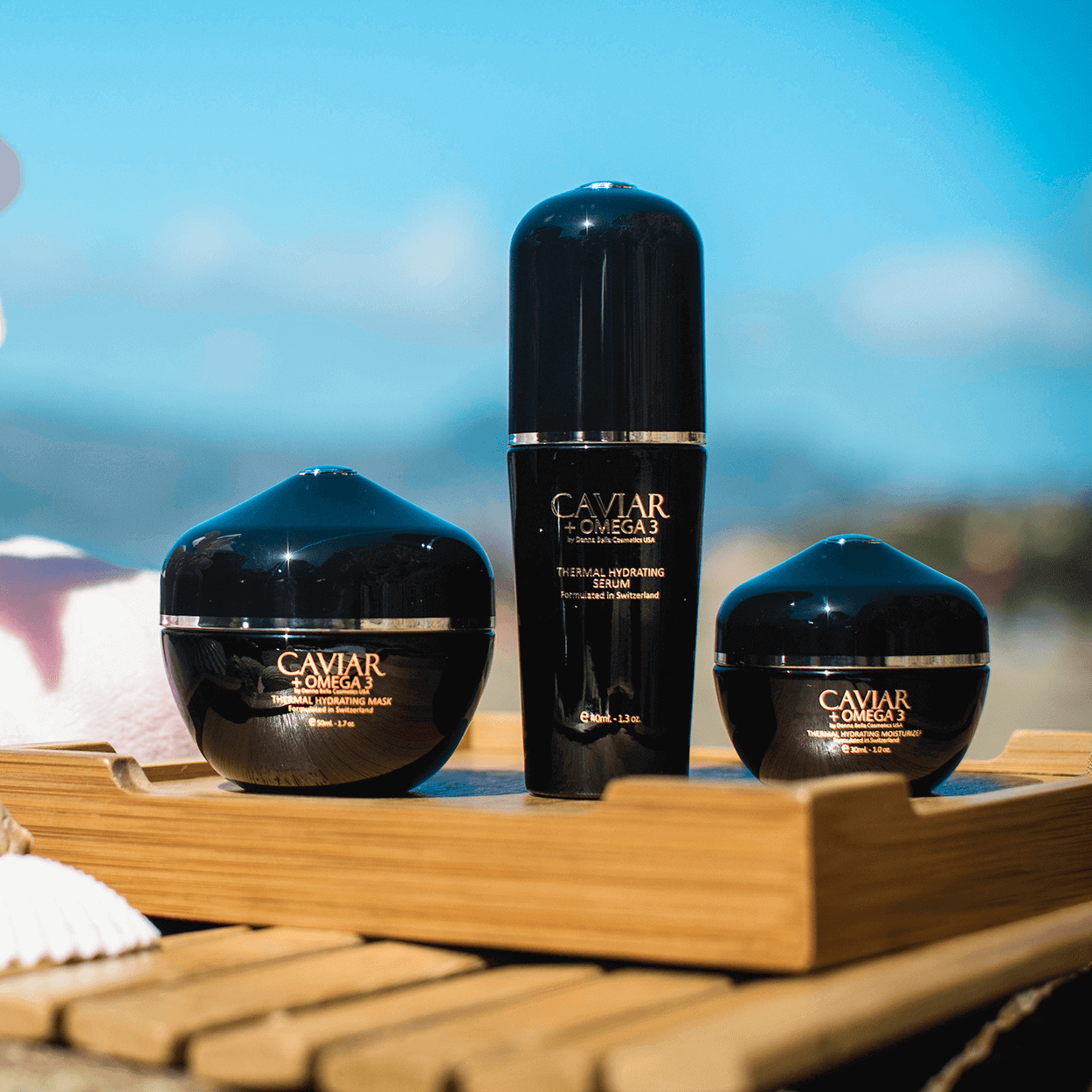 Thermal Hydrating Set featuring Caviar + Omega 3 mask and serum on a wooden tray, ideal for glowing skin.