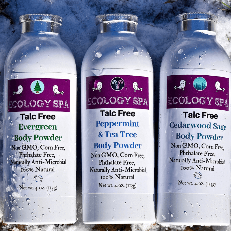 Three Ecology Spa Talc-Free Body Powders: Evergreen, Peppermint & Tea Tree, and Cedarwood Sage in natural setting.