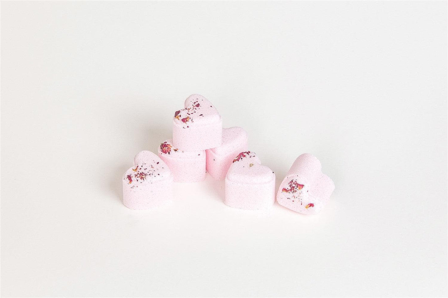 Handmade lavender heart-shaped shower steamers set on a light background, perfect for a relaxing spa experience.