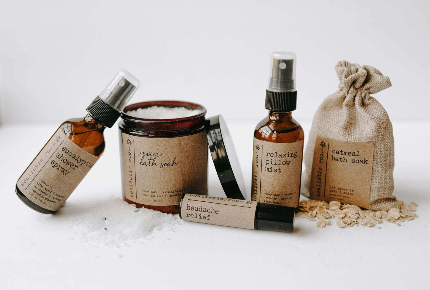 Spa gift set featuring Revive Bath Soak, Headache Relief Roller, Eucalyptus Shower Spray, and Oatmeal Bath Soak.